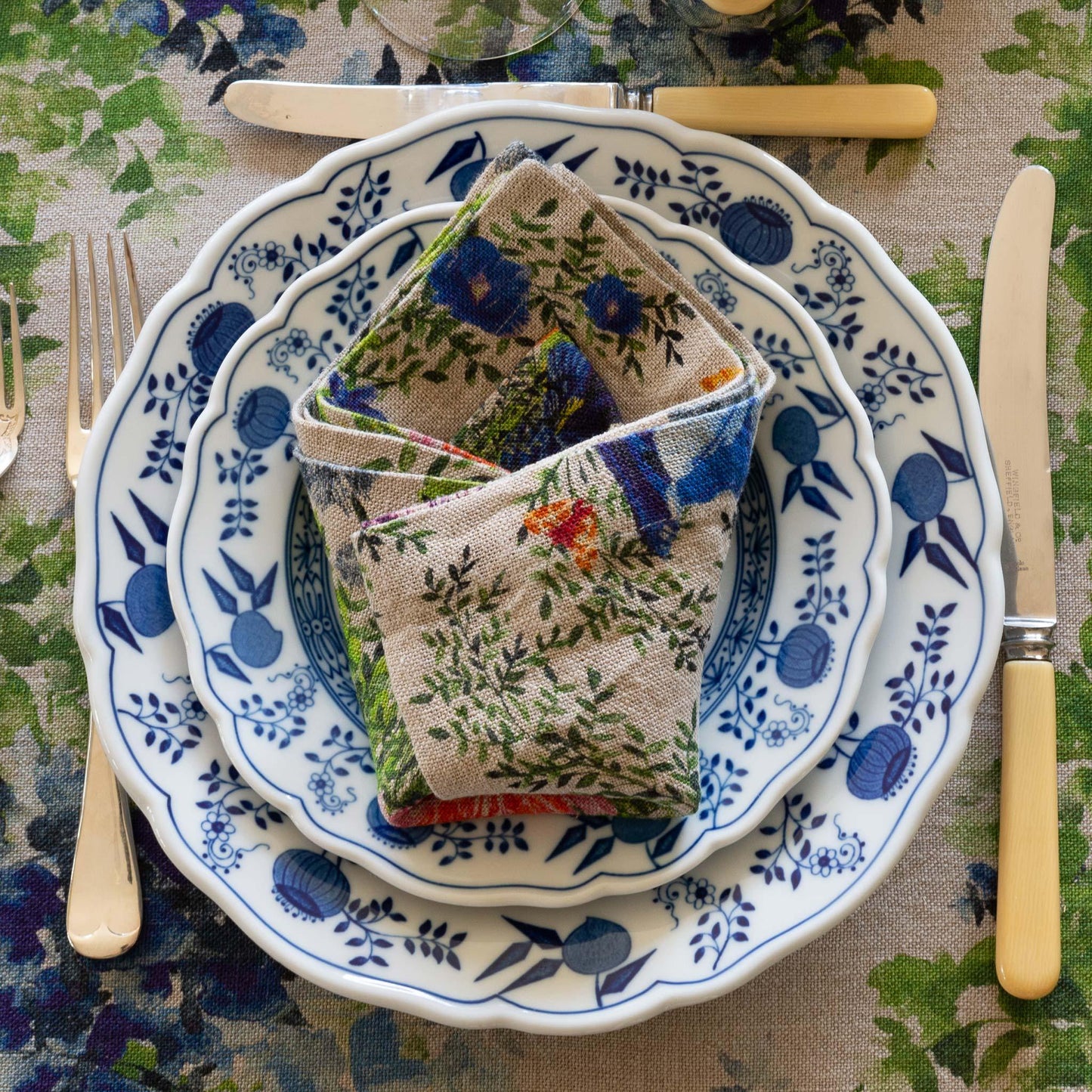 Table setting with colorful floral printed organic linen napkin.