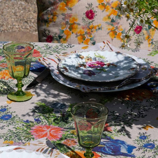 A summer table setting with Sophie Williamson Design Organic Linen Tablecloth and Napkins, plus a floral pillow cover.