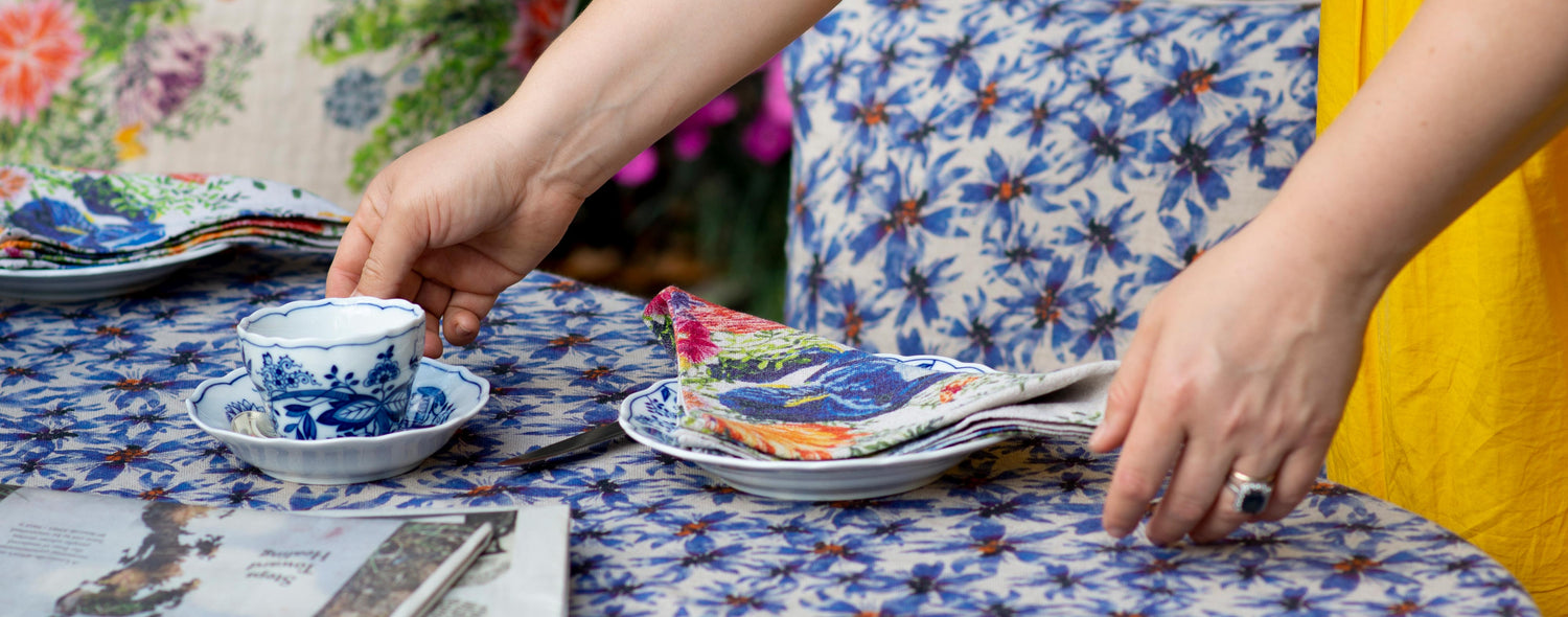 Arranging a table with colorful organic linen tablecloths, organic linen napkins and decorative pillows.