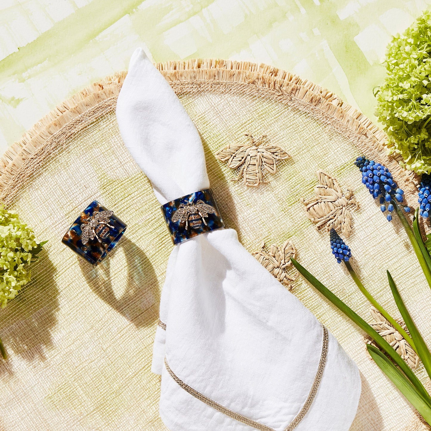 Stripey bee resin napkin rings, blue tortoiseshell, set of four