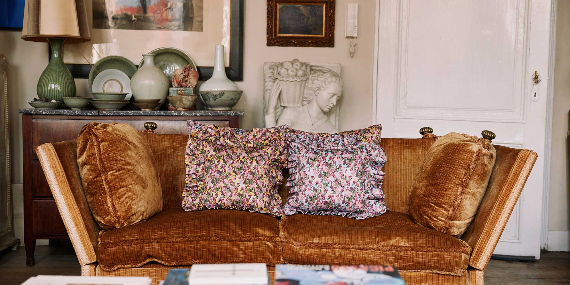 Floral pillows on a velvet sofa 