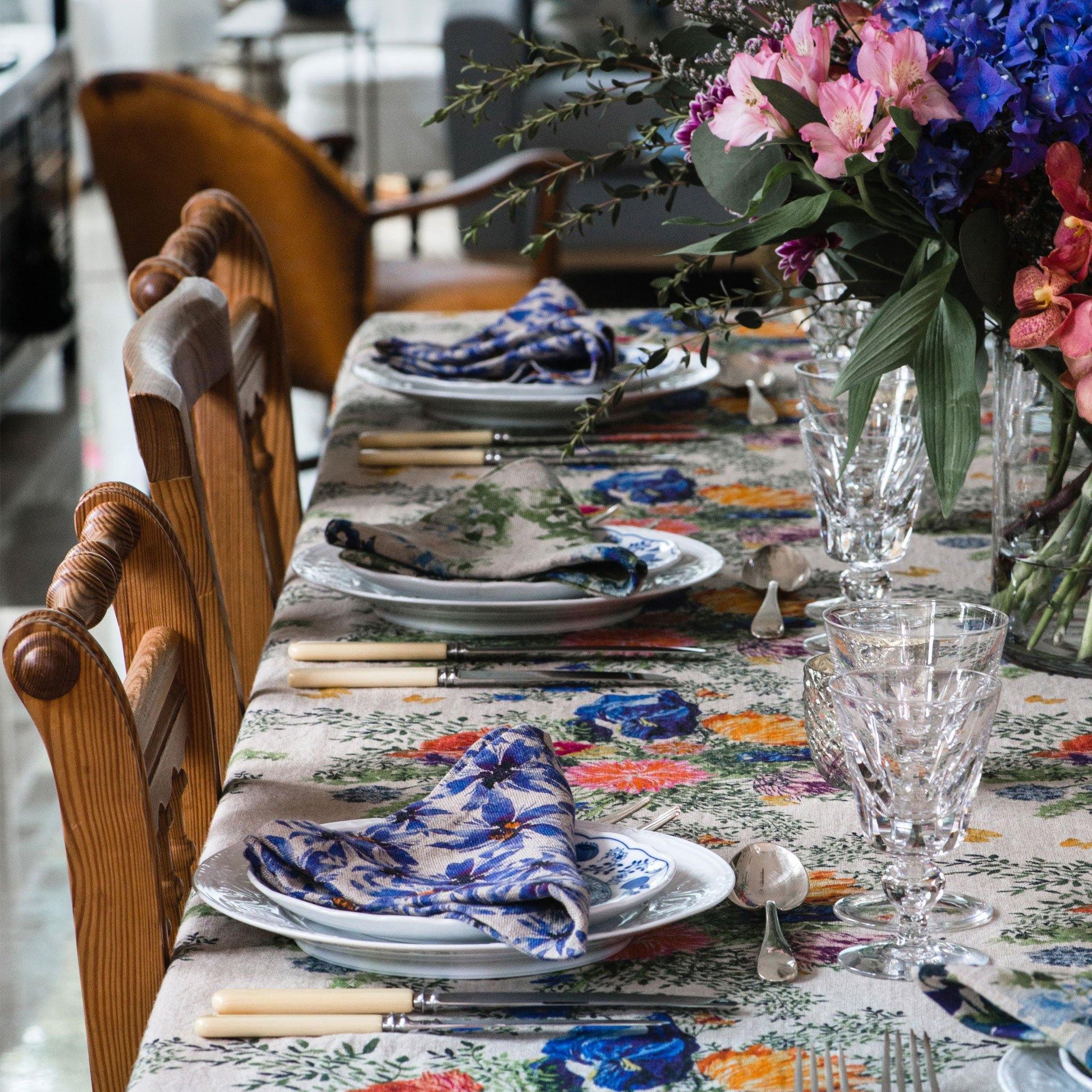 Floral and colorful table scape with organic linen napkins and table cloth.