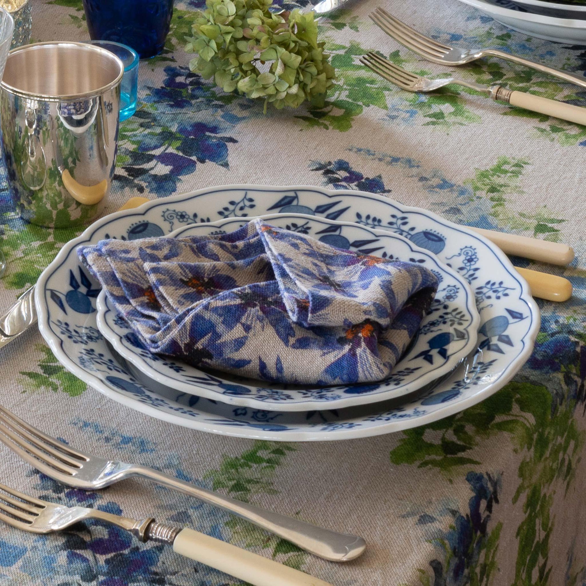 Table setting with blue and white linen napkin.