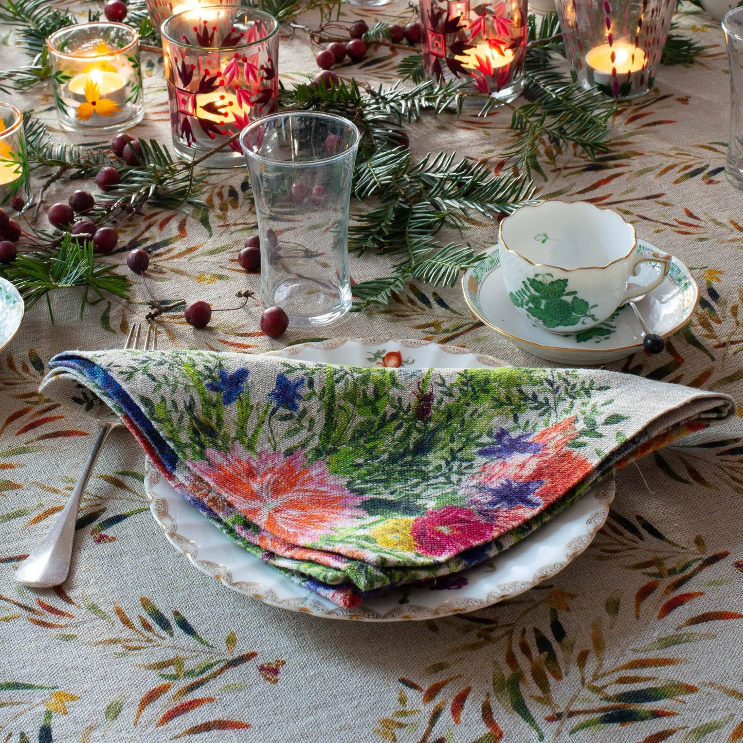 Colorful table scape with floral patterned linen napkin.