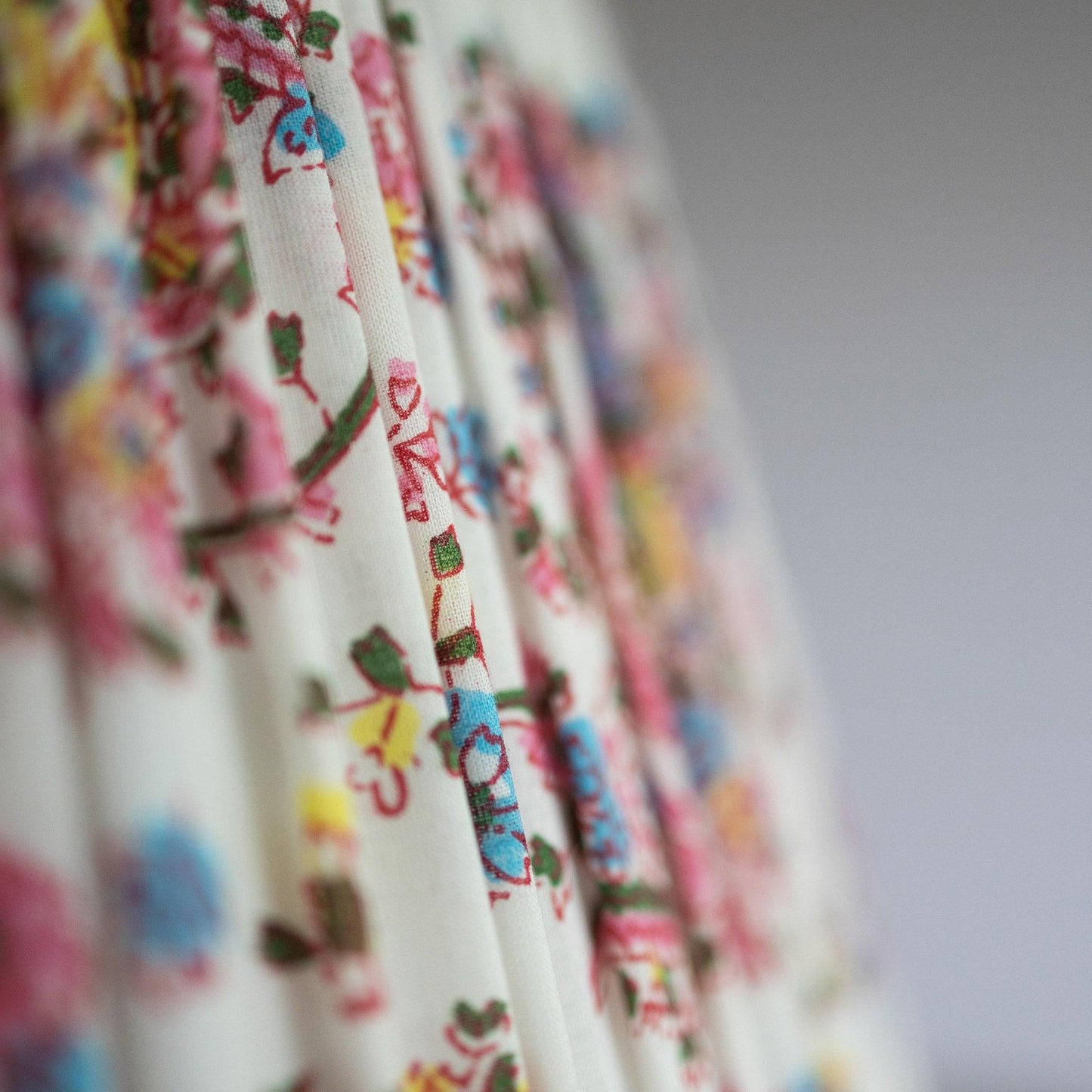 Fabric detail of hand block printed organic cotton pleated lampshade in paisley pink.