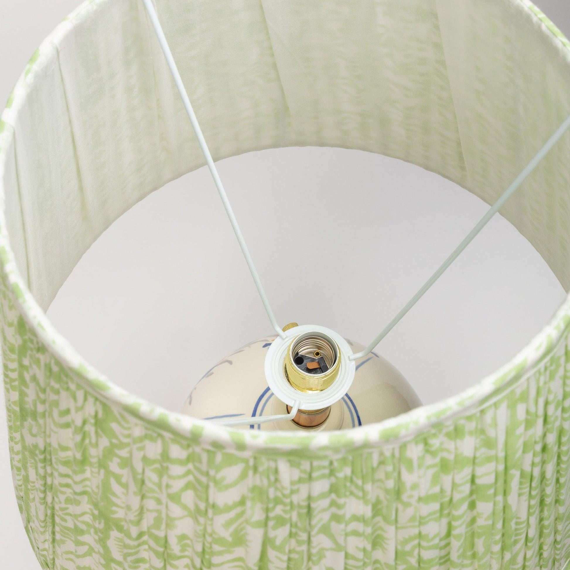 Detail shot of the Uno E26 slip over fitting for organic cotton pleated lampshades in colorful hand block prints.