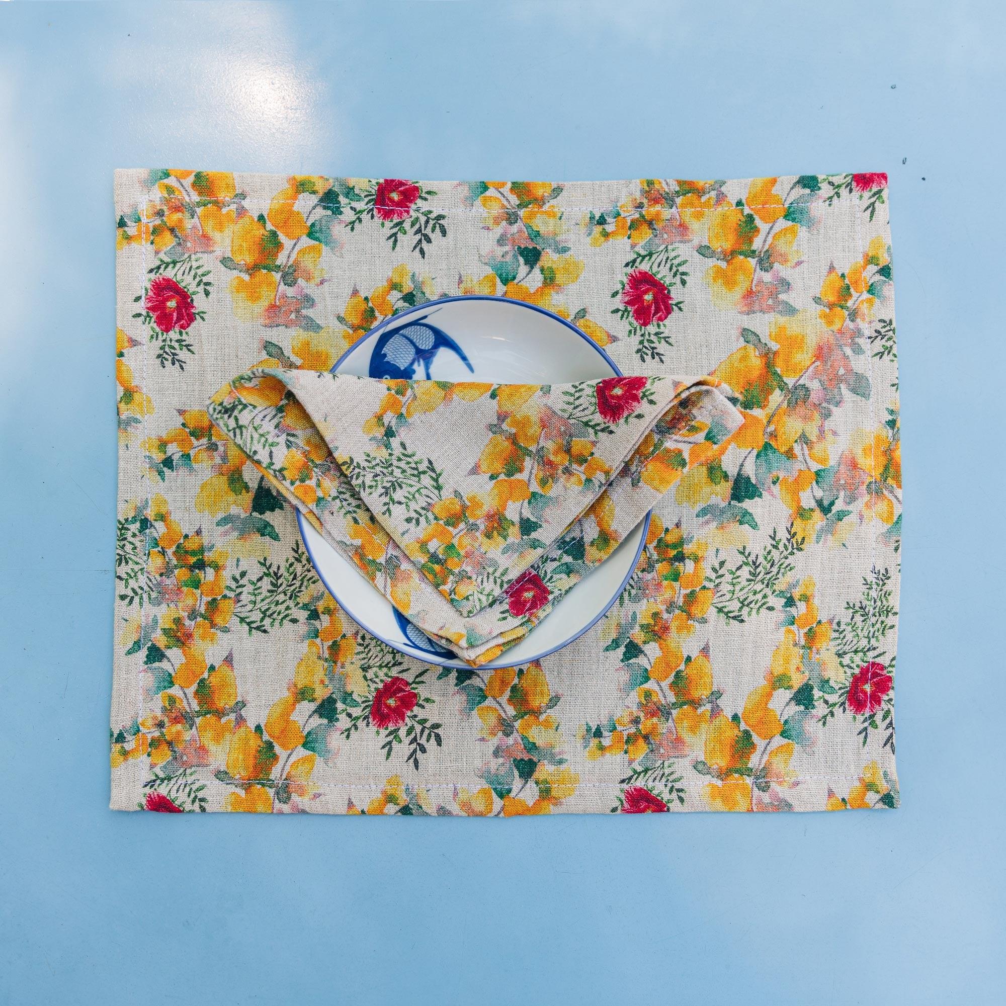 Table setting with organic linen placemat and napkin printed with floral pattern, designed by Sophie Williamson Design.