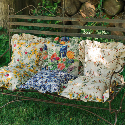 Organic Linen Square Pillows with Ruffled printed with bright floral prints on Organic Linen, photographed in an outdoor setting.
